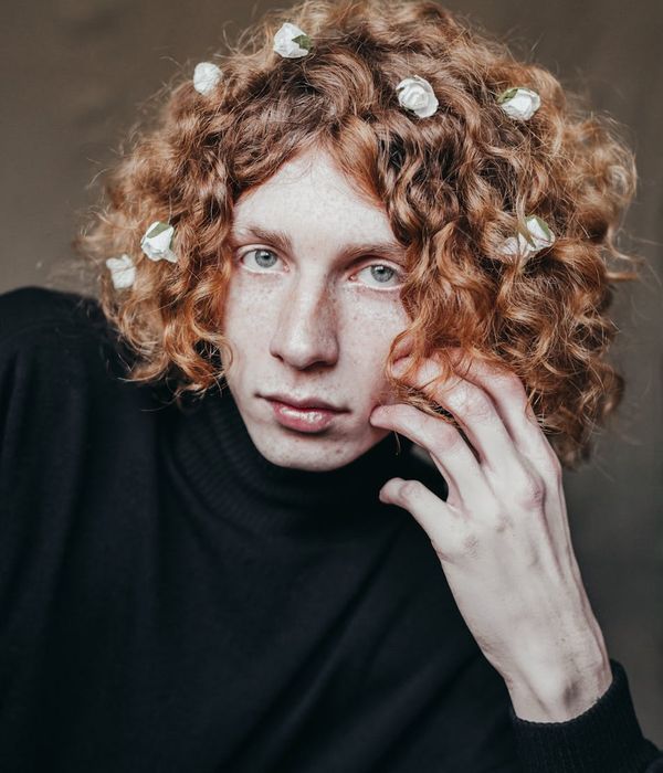 Young woman looking into the distance with relaxed facial expression.